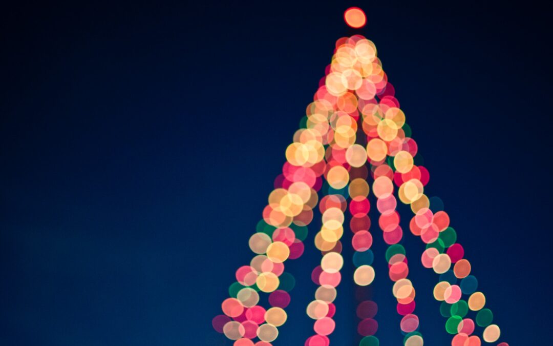 Colorful string lights creating the shape of a Christmas tree