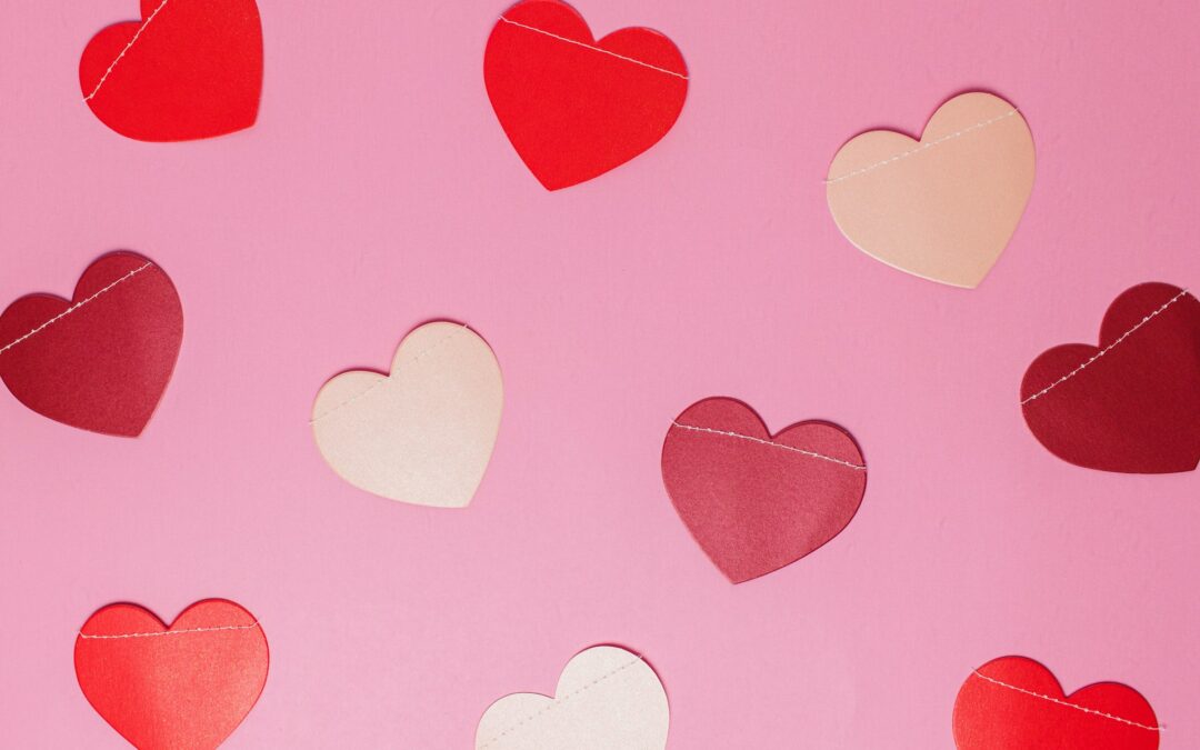 Red and white hearts on a pink background
